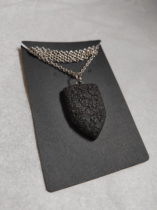Black textured pendant with chain and leather cord